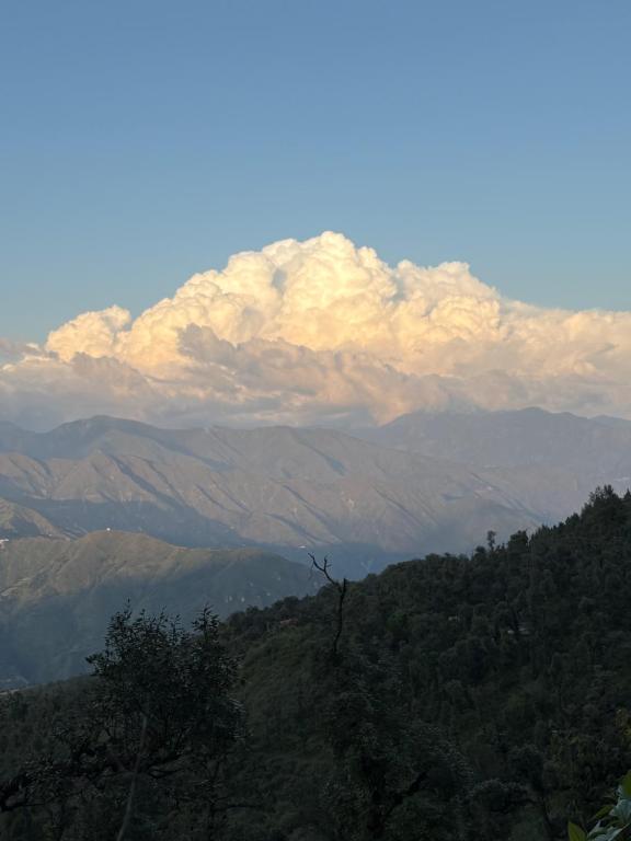 a view of a mountain range with a cloudy at On Road View in Mussoorie