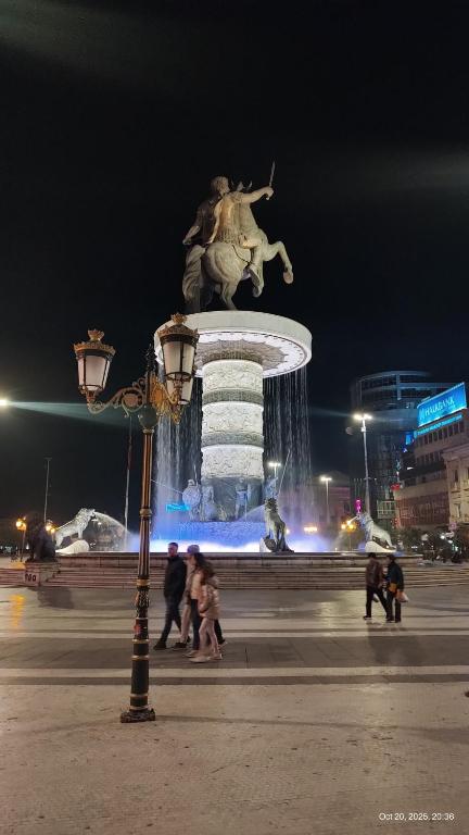 a statue of a man on a horse in front of a fountain at View in Skopje