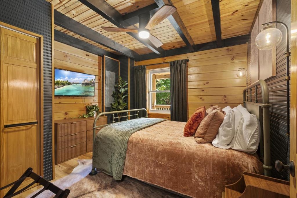 a bedroom with a bed and a television at Hot Tub & WiFi - Hillside Haven Red River Gorge KY in Rogers