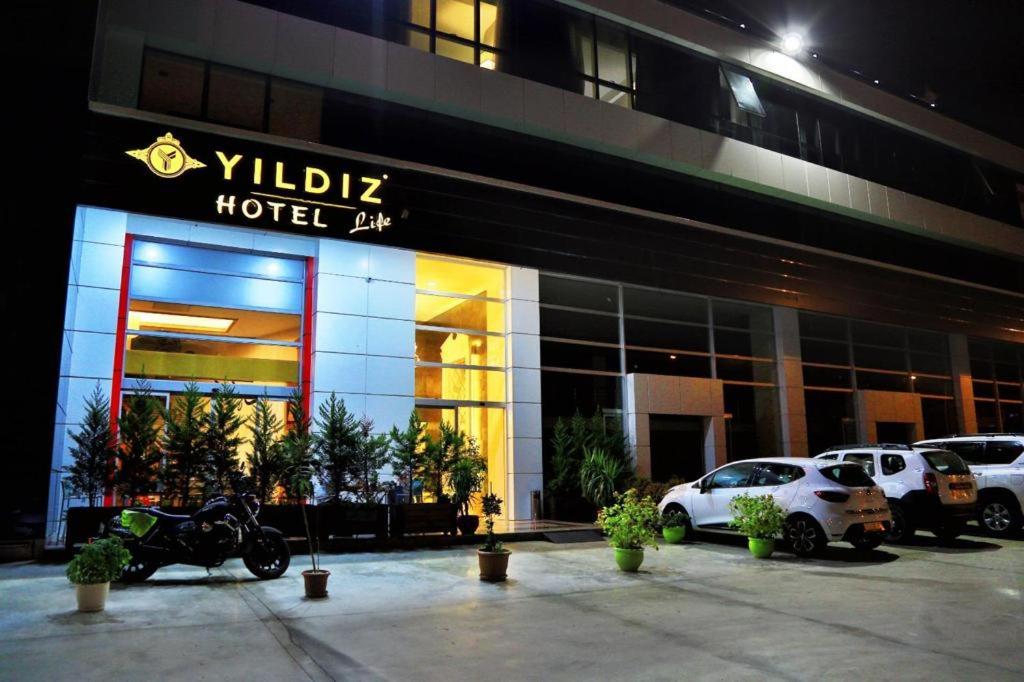 a hotel with a motorcycle parked in front of it at Yildiz Life Hotel in Trabzon