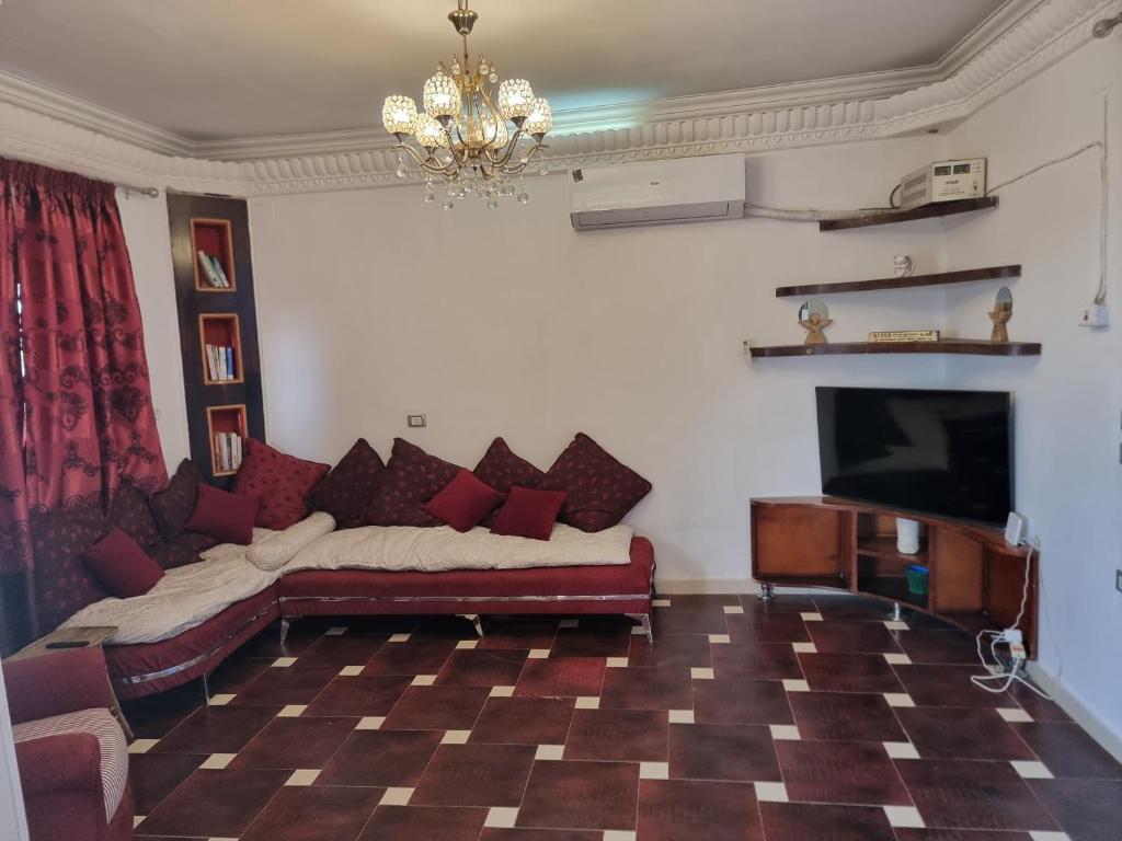 a living room with a couch and a flat screen tv at Adream partment in Luxor in Luxor