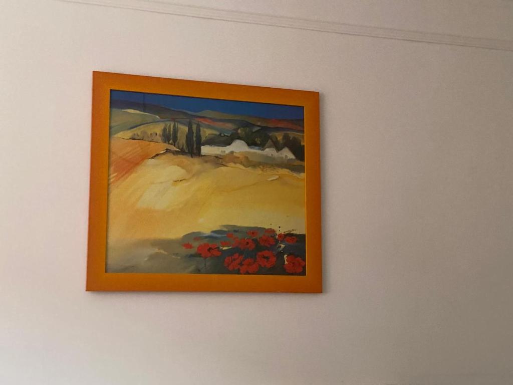 a picture of a painting on a wall at Azure Horizon in Hannover