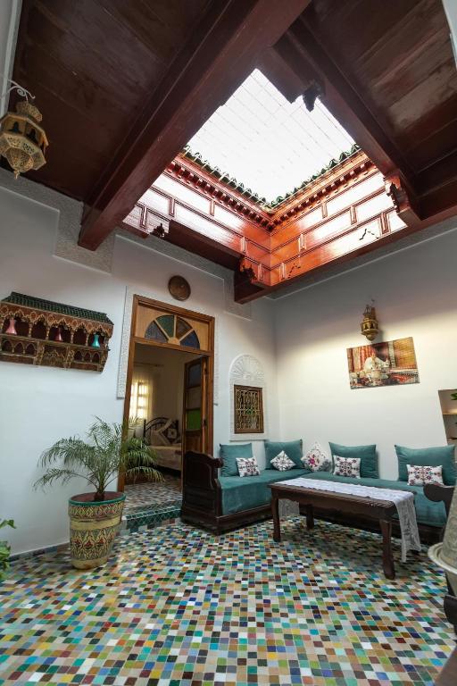 a living room with a couch and a table at Dar El Kendil in Fez