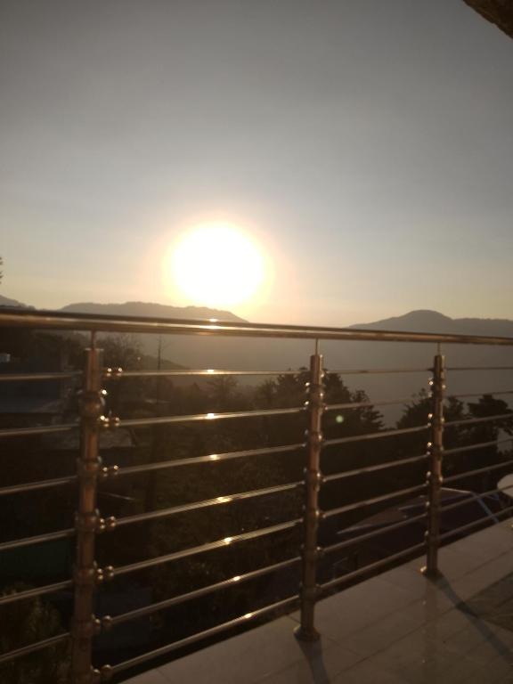a view of the sun setting over the water at Murree top hotel in Murree