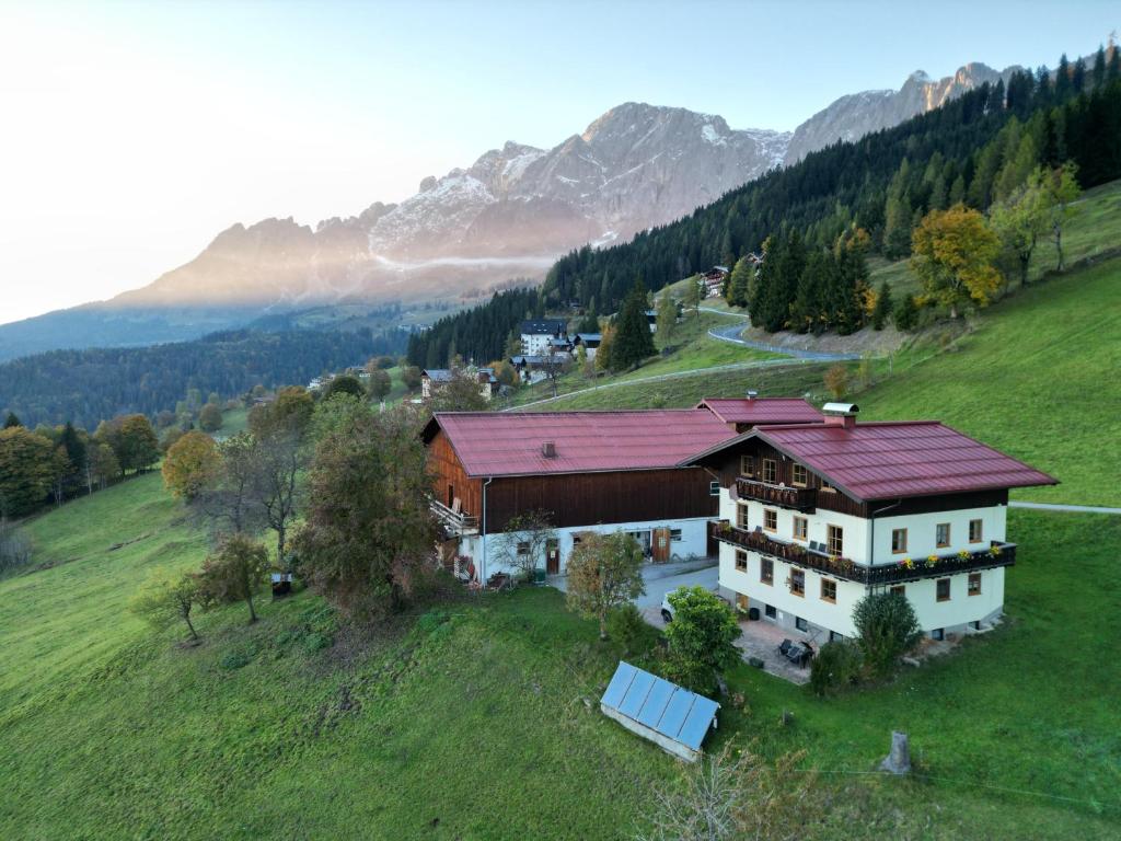 an aerial view of a house on a hill at Molteraugut in Mühlbach am Hochkönig