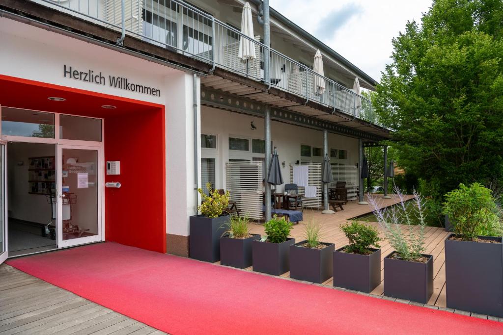 a red door of a hotel with a red carpet at Schneeeule 204 in Granzow