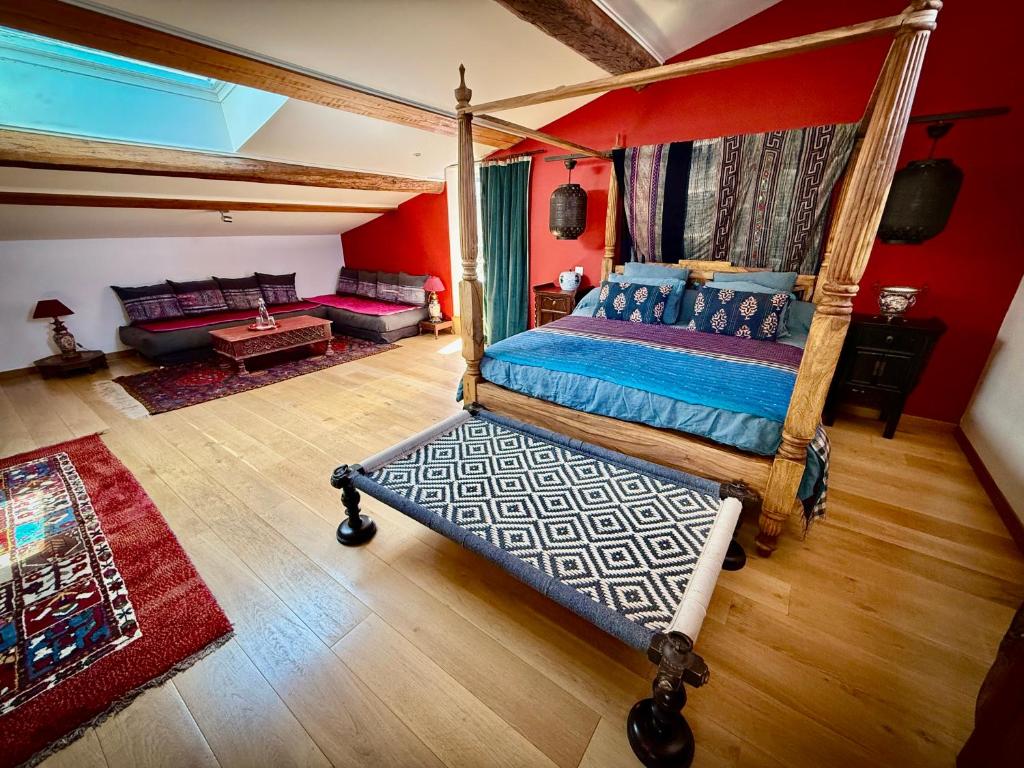 a bedroom with a canopy bed and a living room at Origines in Tautavel