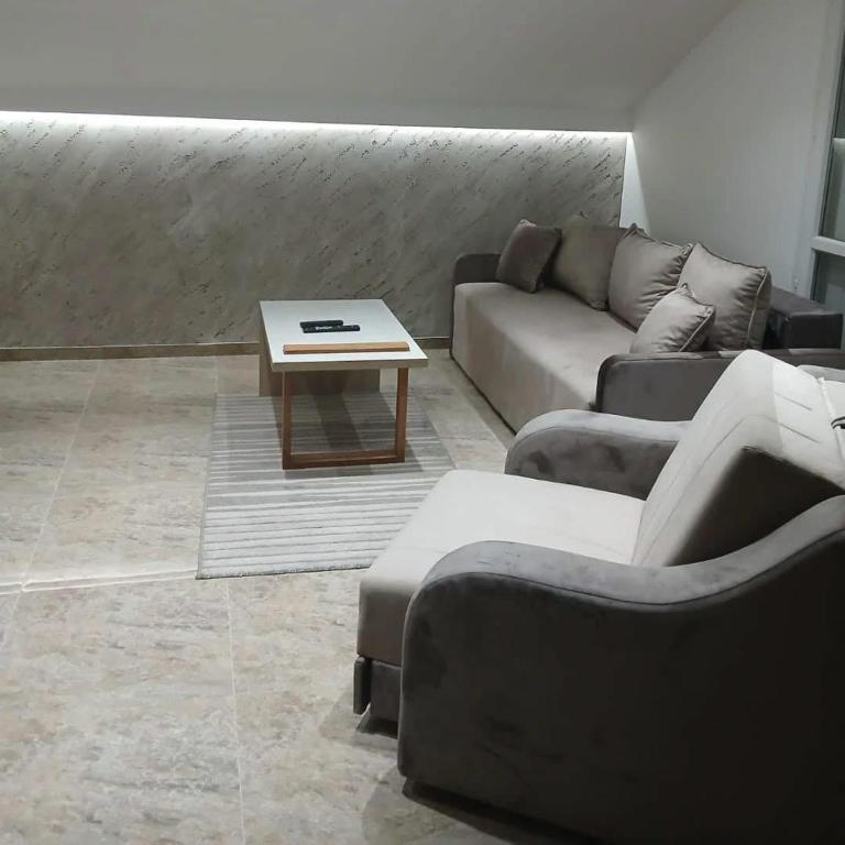 a living room with a couch and a coffee table at Stan Na Dan in Velika Plana