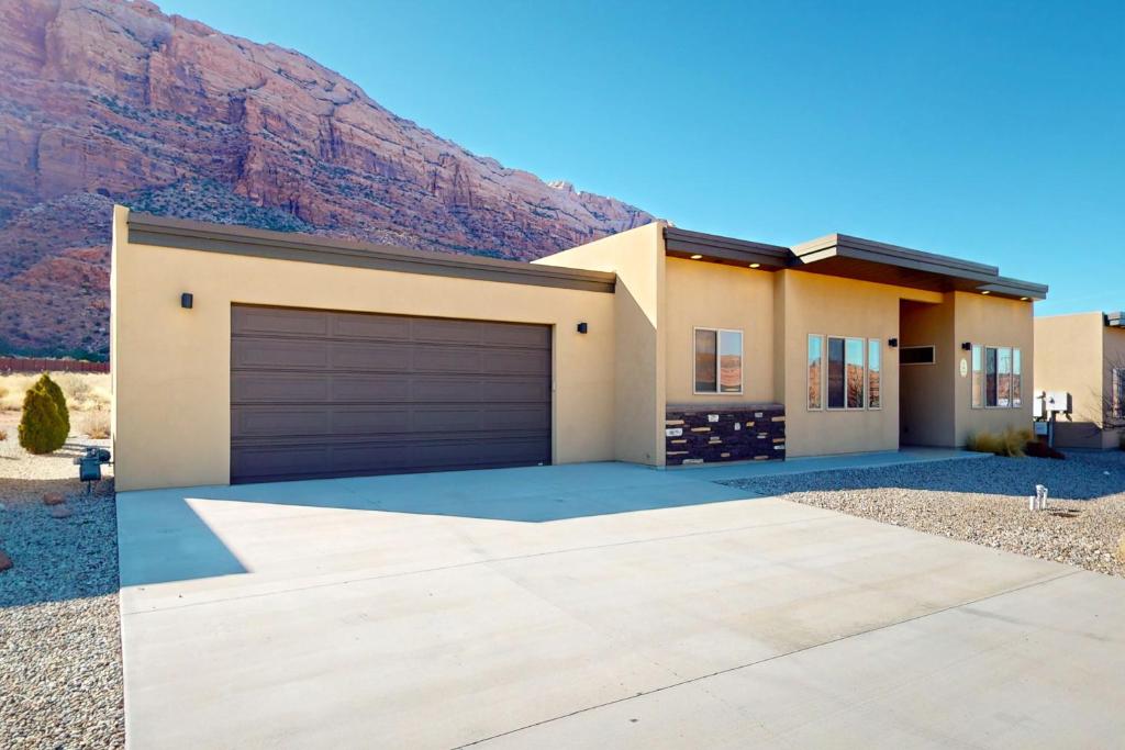 a house with a mountain in the background at Rim View 6 in Spanish Valley