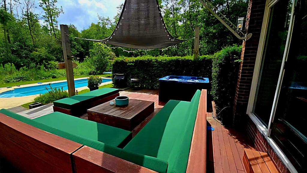 a backyard with a table and a swimming pool at Villa in the forest of Amsterdam with Pool in Velsen-Zuid