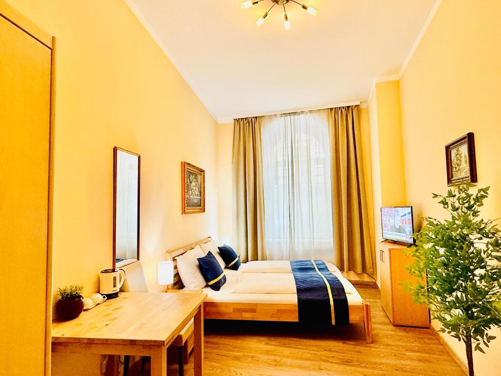 a hotel room with a bed and a table at Pension Liechtenstein in Vienna