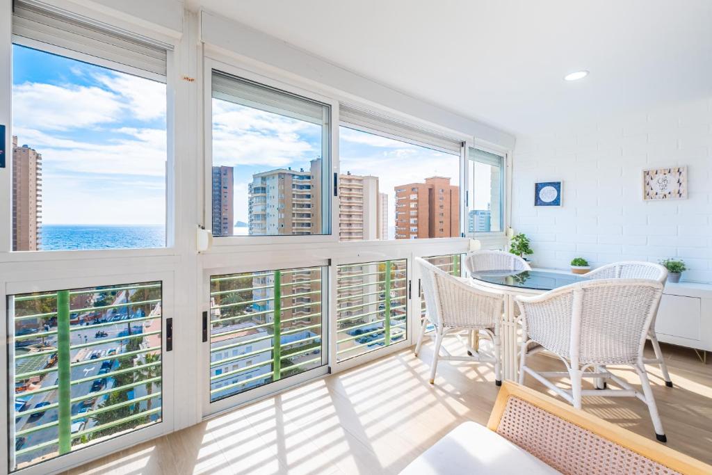 a balcony with two chairs and a view of the ocean at Niza 11-A Apartment Levante Beach in Benidorm