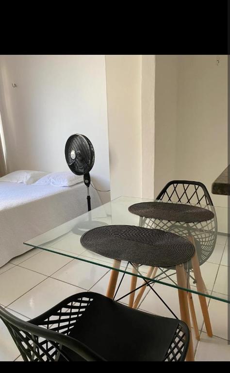 two chairs and a glass table in a room at Luxo in Caruaru