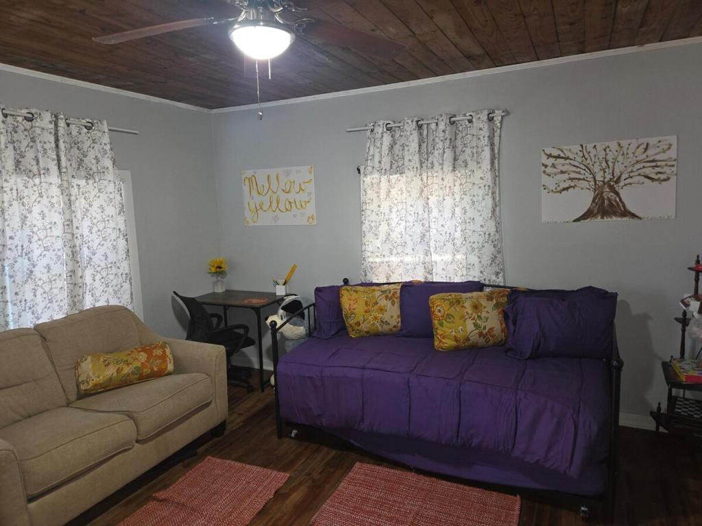 a living room with a purple couch and a table at Yellow Mellow in Jackson