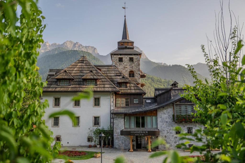 a building with a tower on top of it at Hammerack Hotel, SPA & Wellness in Malborghetto Valbruna