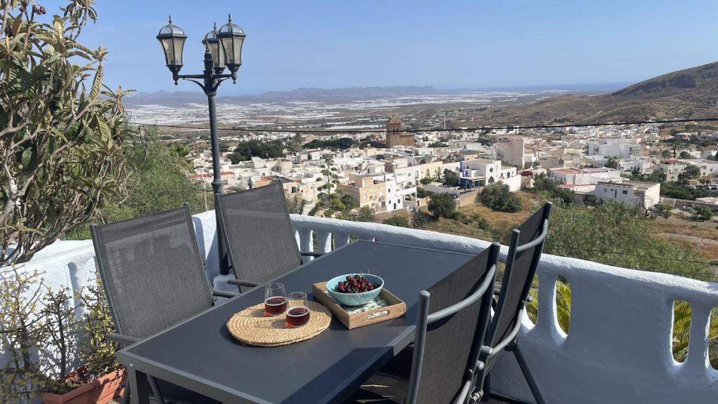 a table with a plate of food on top of a balcony at Casa Cueva Solara, peace and nature in Cabo de Gata in Níjar