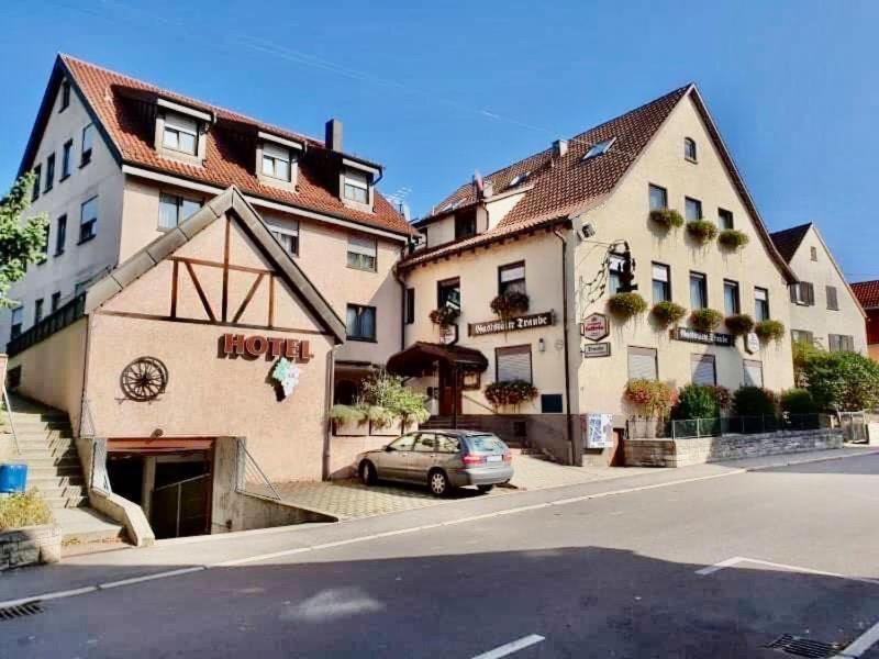a car parked in front of a hotel on a street at Hotel Neue Traube in Fellbach