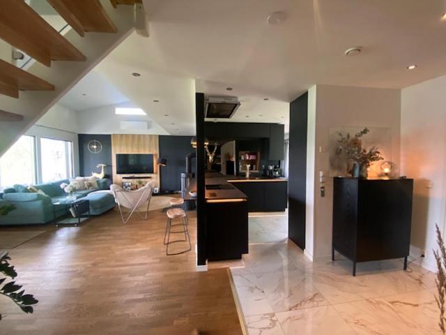 a large living room with a kitchen and a living room at Lapland Riverside Home in Rovaniemi