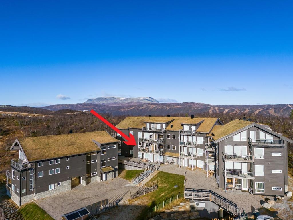 an aerial view of an apartment complex with a red arrow at Kikut Panorama Geilo Ski-in Ski-out in Geilo