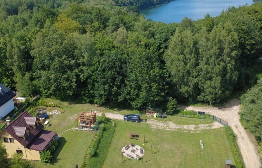 an aerial view of a large field with a house and trees at Domek pod Dębami Bogaczewo in Bogaczewo