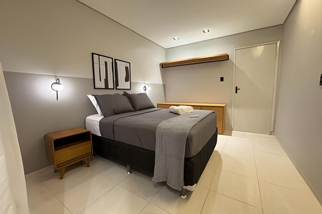 a bedroom with a large bed and a walk in closet at Apartamento no centro! Próximo a tudo! in Barreiras