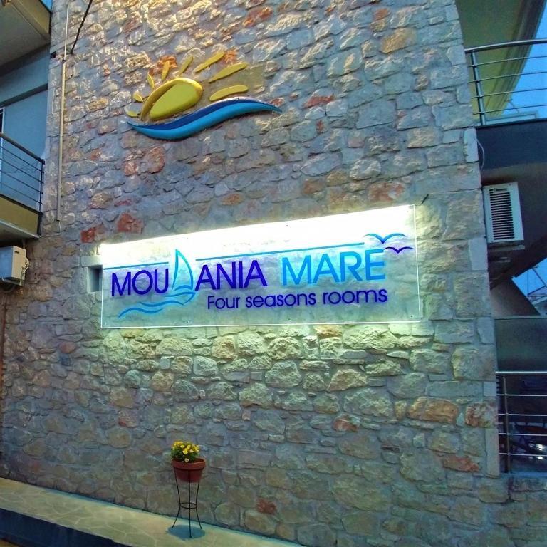una señal en el costado de una pared de piedra en Moudania Mare, en Nea Moudania