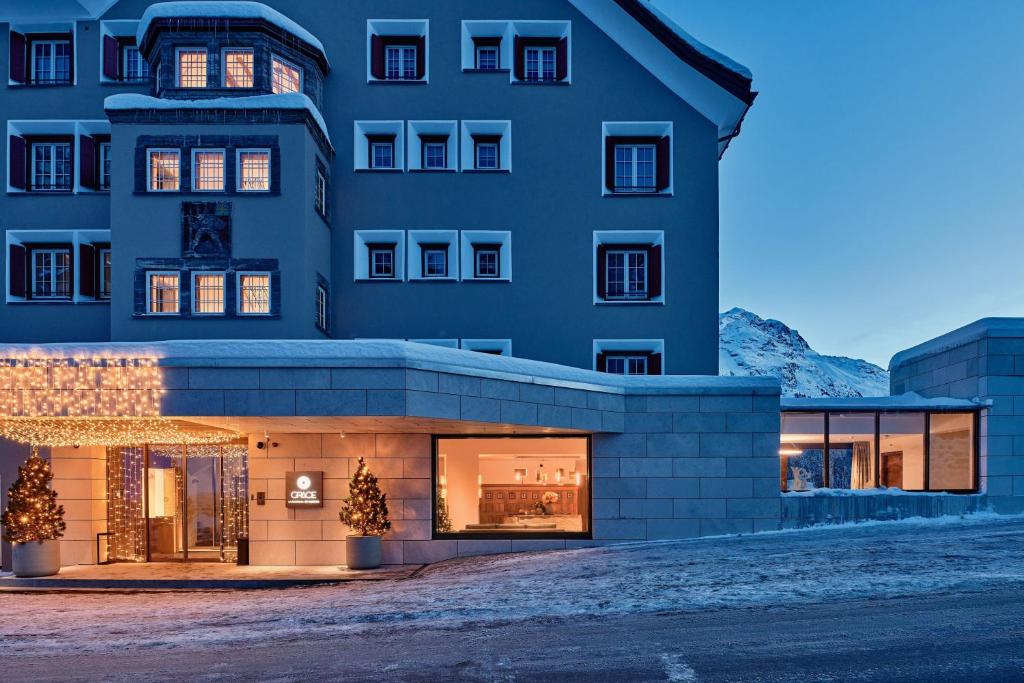 a building with christmas trees in front of it at Hotel GRACE LA MARGNA ST MORITZ in St. Moritz