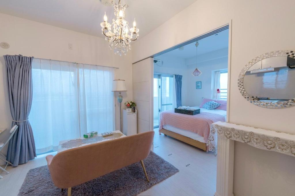 a bedroom with a bed and a mirror at 沖縄SunSea海景酒店整套公寓 那霸机场20分钟车程 