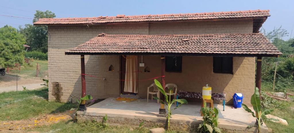 a small brick house with a roof at Shivalika home stay in Maheshwar