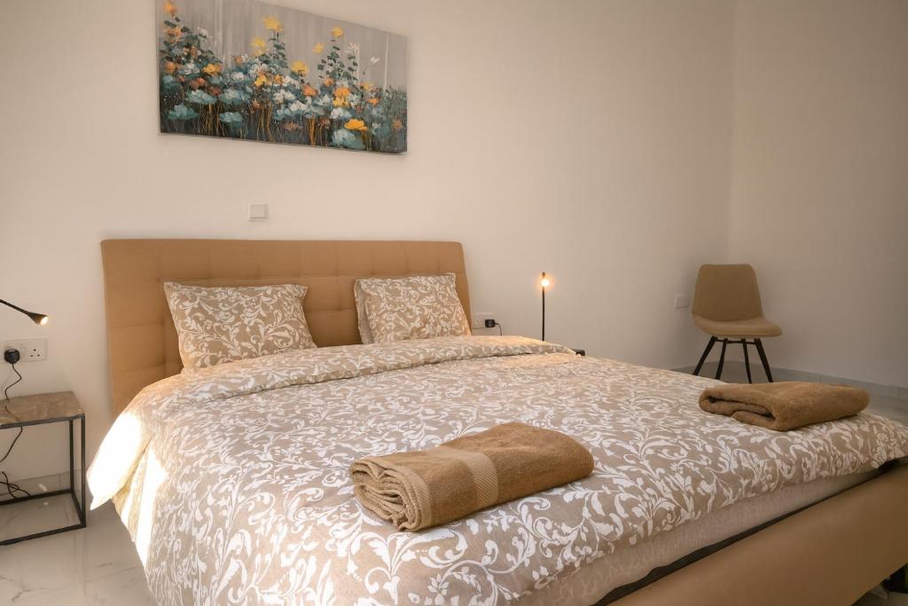 a bedroom with a bed with two towels on it at Limassol Centr Apartament in Limassol