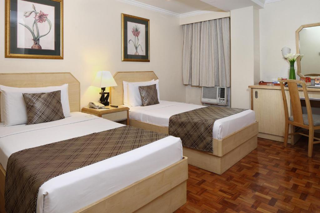 Postel nebo postele na pokoji v ubytování Manila Lotus Hotel