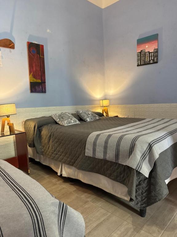 a bedroom with a large bed and two lamps at Casa del Arte in Salta