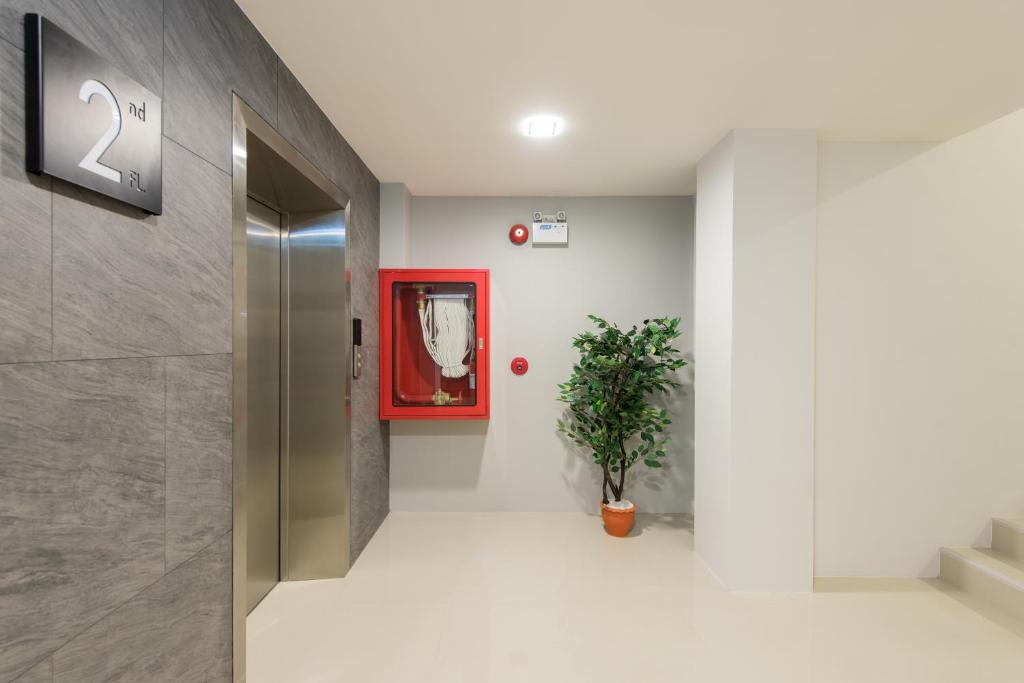 A clean upper-floor corridor beside the elevator and stairwell.