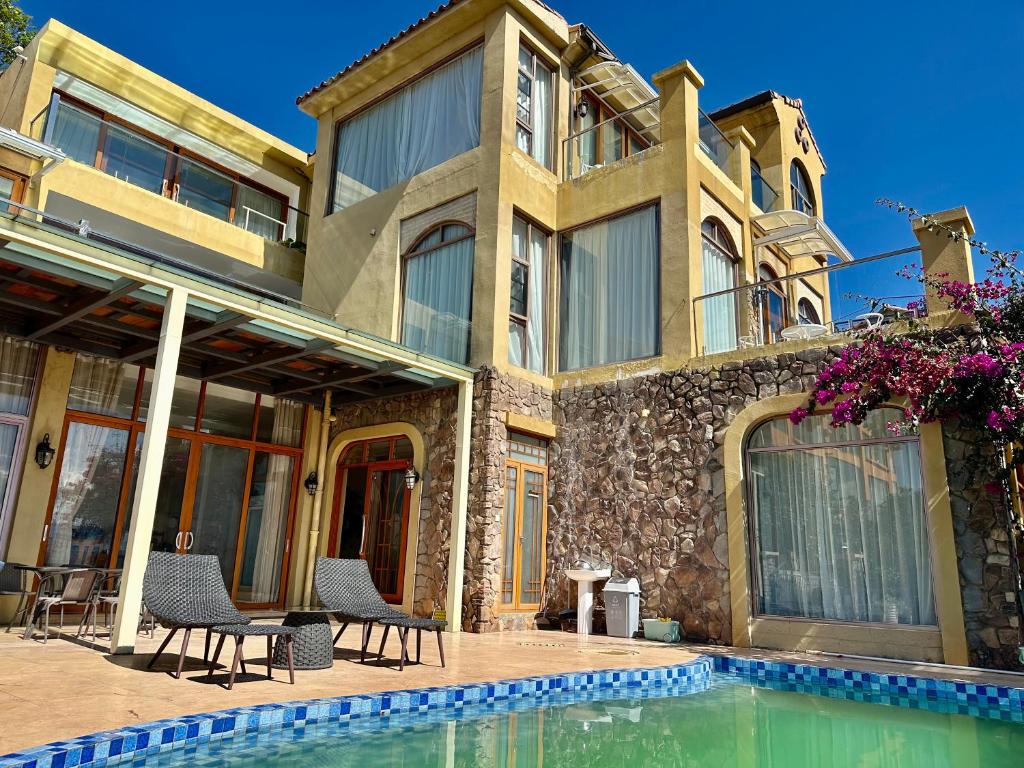 a house with a swimming pool in front of it at Dali Tanuki Fantasy Seaview Villa in Dali