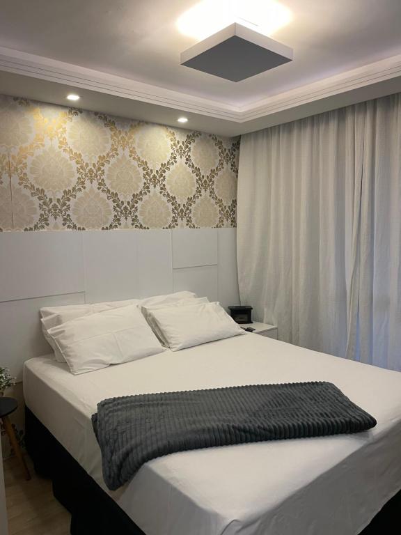 a bedroom with a large white bed in a room at Batel Guest House-Suite Queen Quarto 1 in Curitiba
