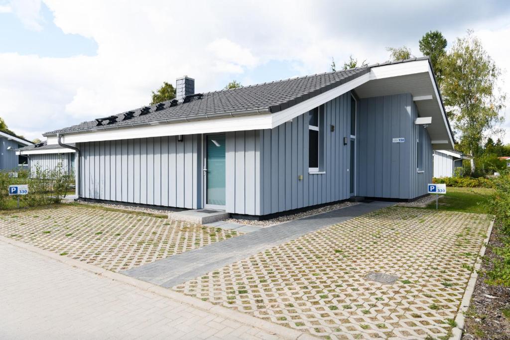 a home with a gray and white garage at Seeschwalbe 330 in Mirow