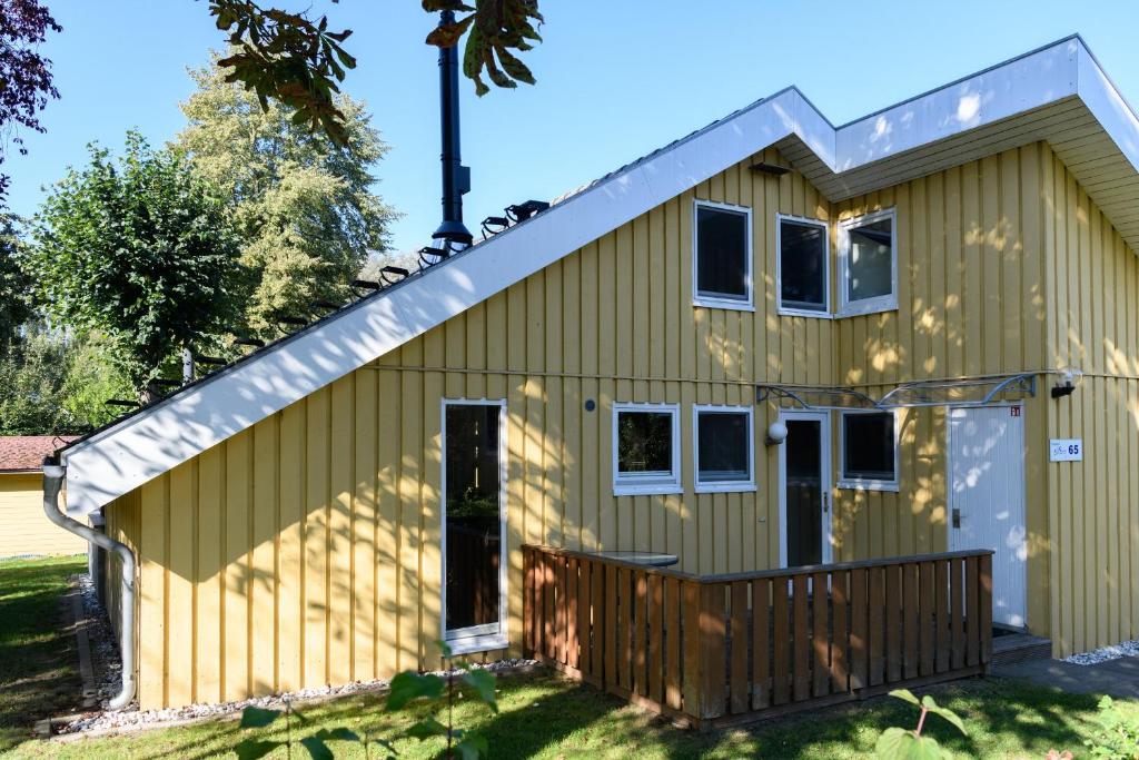 a yellow house with a gambrel roof at Wildgans 65 in Mirow