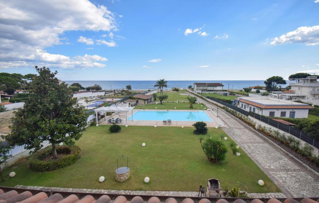 an aerial view of a park with a swimming pool and the ocean at Villa Baia Del Circeo in Colonia Elena