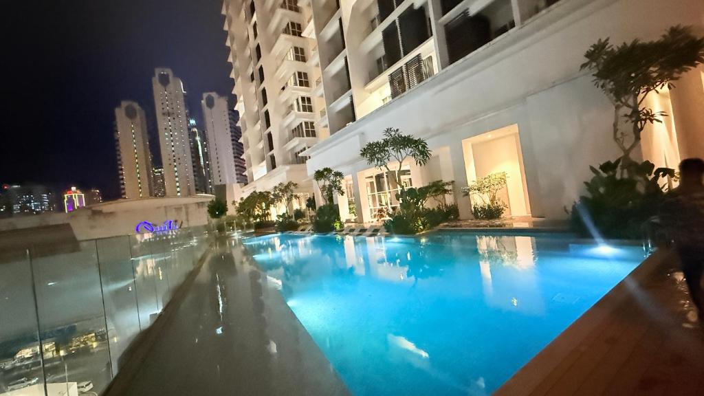 a large swimming pool in a building at night at Quill City Centre Residences Suites KLCC in Kuala Lumpur