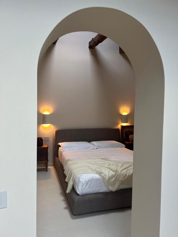 a bedroom with a large bed in an archway at Can Los arcos in Chioggia