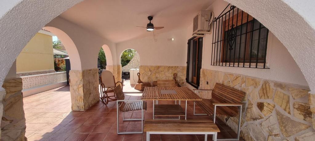 a row of benches in a building with an archway at El Porche de Calabardina Playa - By Aloha Palma in Calabardina