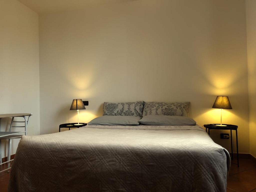 a bedroom with a bed with two lamps on both sides at YAWHome B&B in Bologna