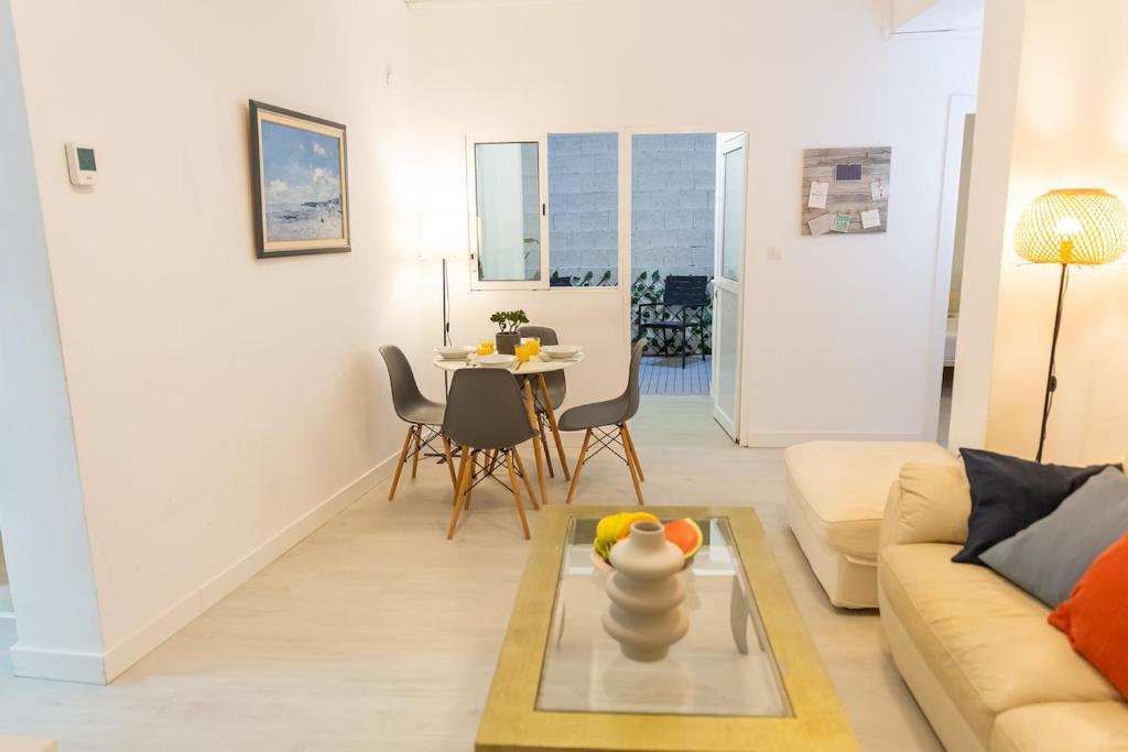 a living room with a couch and a table at Canasteros Apartments ! in Málaga