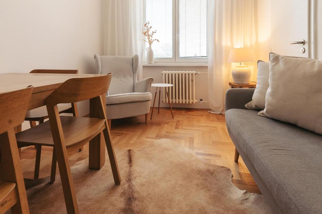 a living room with a couch and a table at apartmán NA NOC V BOHDANČI in Lázně Bohdaneč