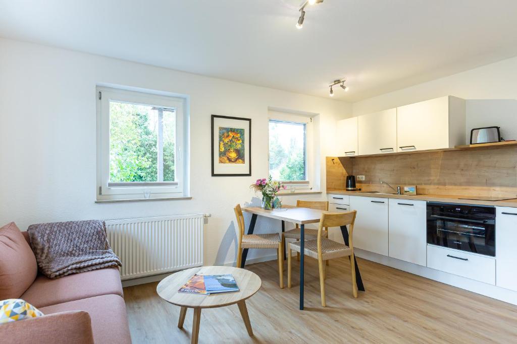 a kitchen and living room with a couch and a table at Boddenräuber 3 in Ahrenshoop