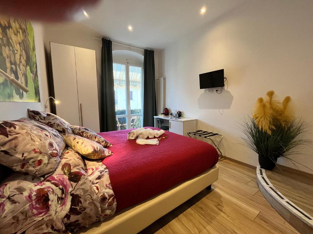 a bedroom with a bed with a red blanket at Al molo 21 in La Spezia