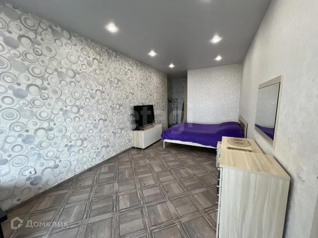 a bedroom with a purple bed and a wall at Ruhiger Hafen in Burghaun