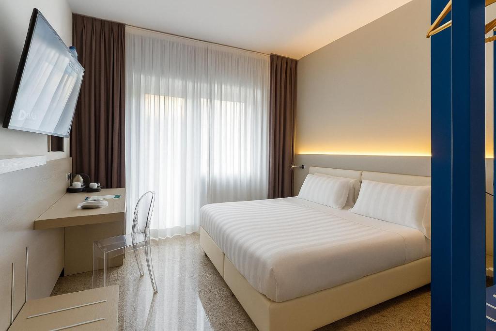 a hotel room with a bed and a television at Hotiday Diano Marina in Diano Marina