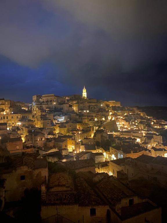 a view of a city at night at La casa di Thomas in centro in Matera