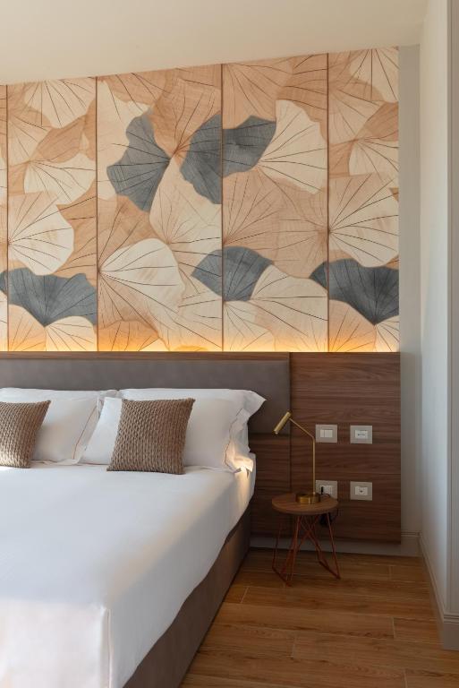 a bedroom with a large bed with a wooden headboard at Openhouse Stay in Fano